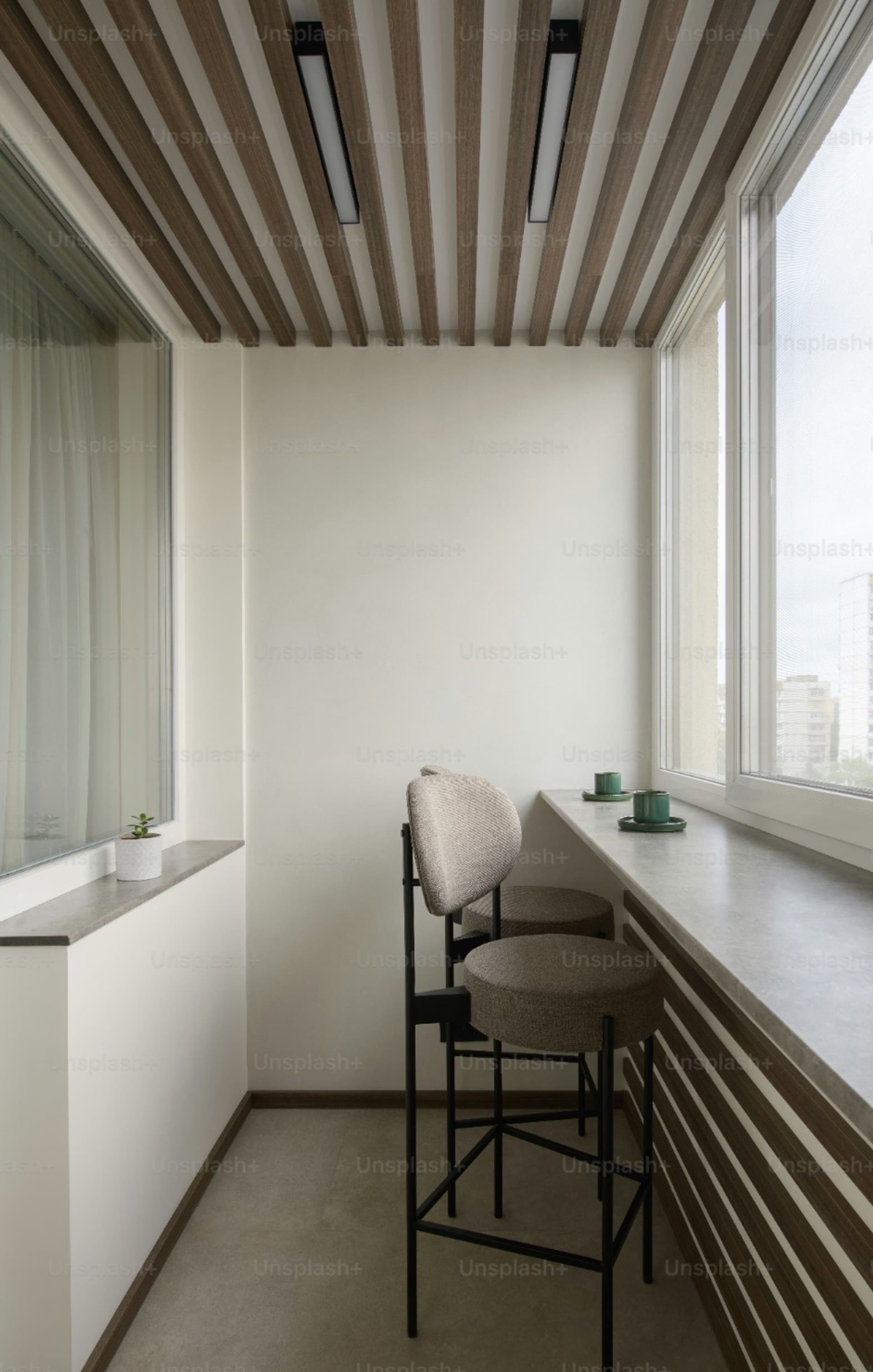 bar with two stools facing a window