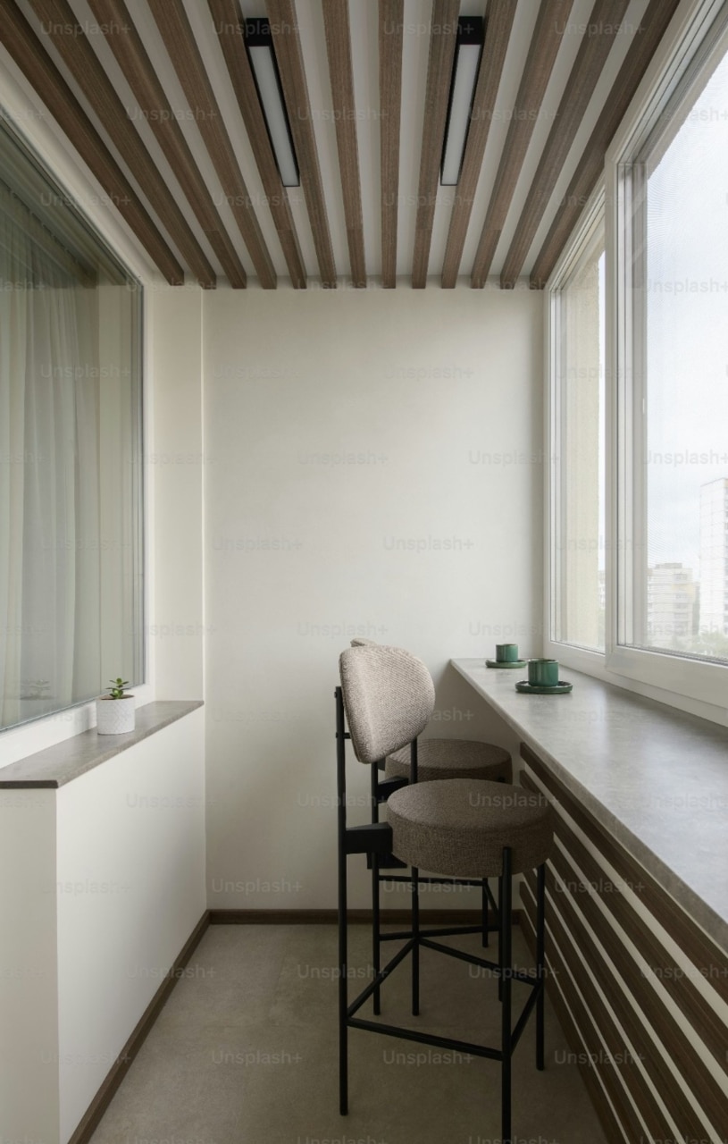 bar with two stools facing a window