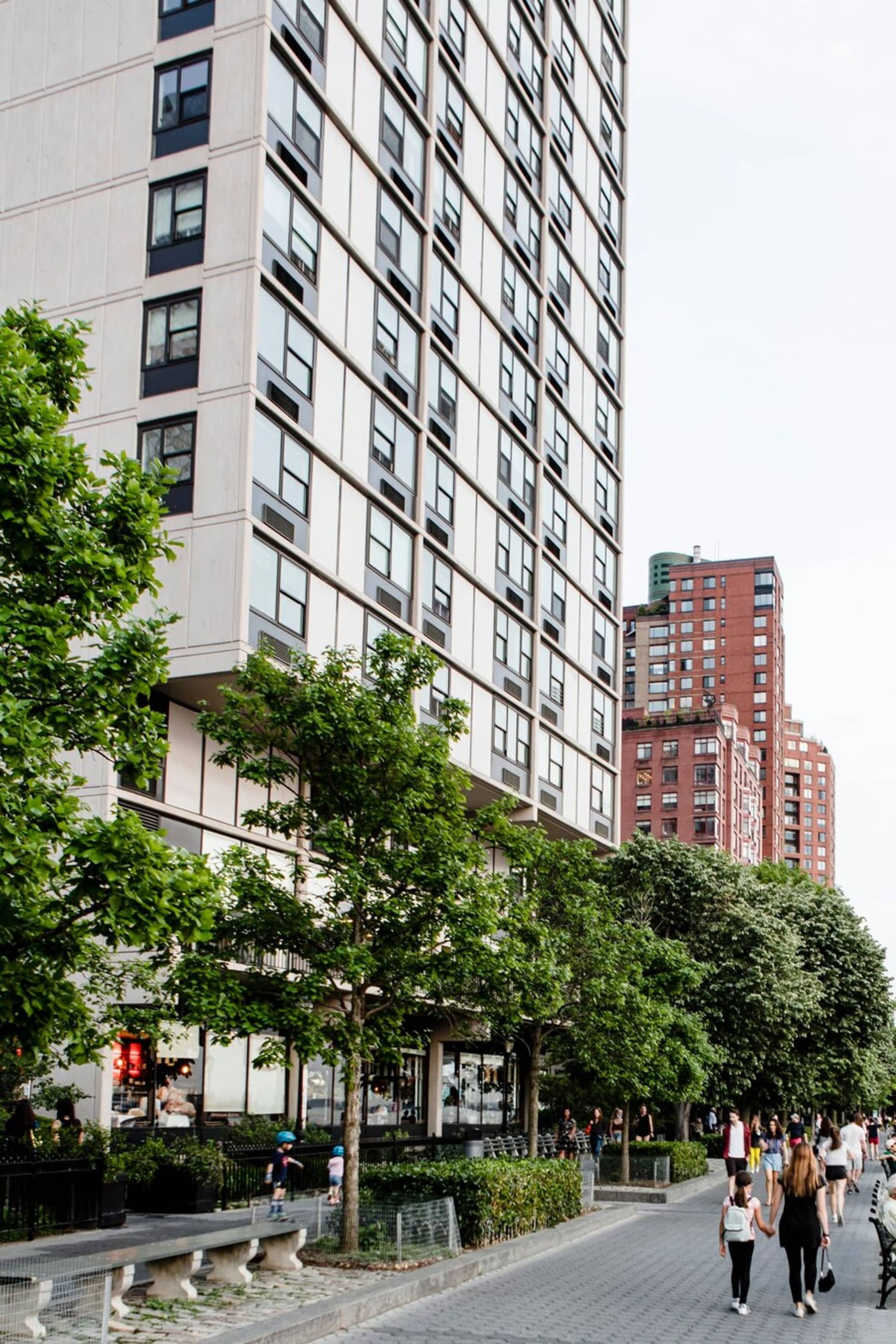 Street scene with tall buildings and people walking by