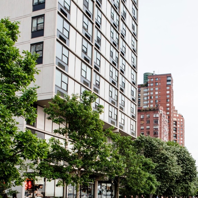 Street scene with tall buildings and people walking by