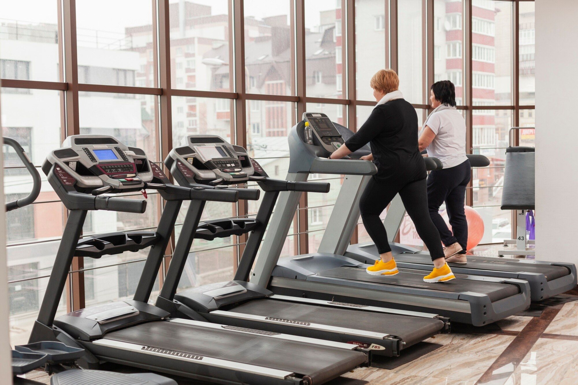 two people working out on treadmills