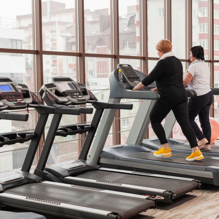 two people working out on treadmills